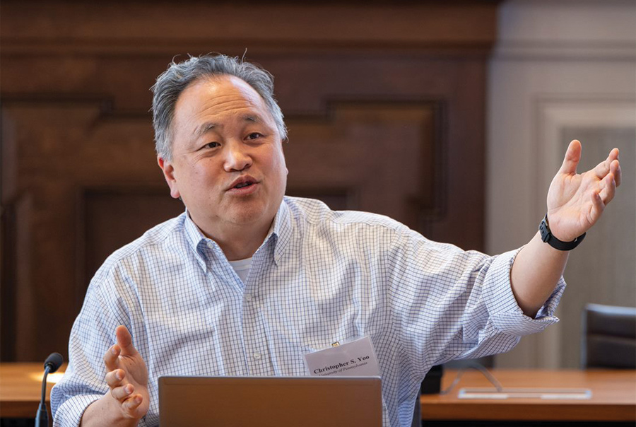 Christopher S. Yoo gesturing during a talk.