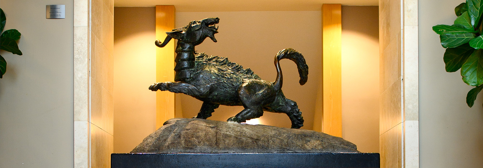 A landscape photograph of the Hsieh-chai (affectionally known as "The Goat") bronze sculpture located within a Penn Carey Law school building where it is a popular meeting spot for all people to mingle and connect with each other