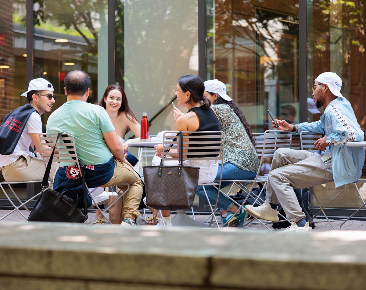 a group of law students sit at an outdoor table together
